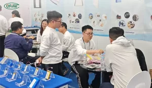 Ufine Battery team discussing battery requirements with visitors at KES 2025